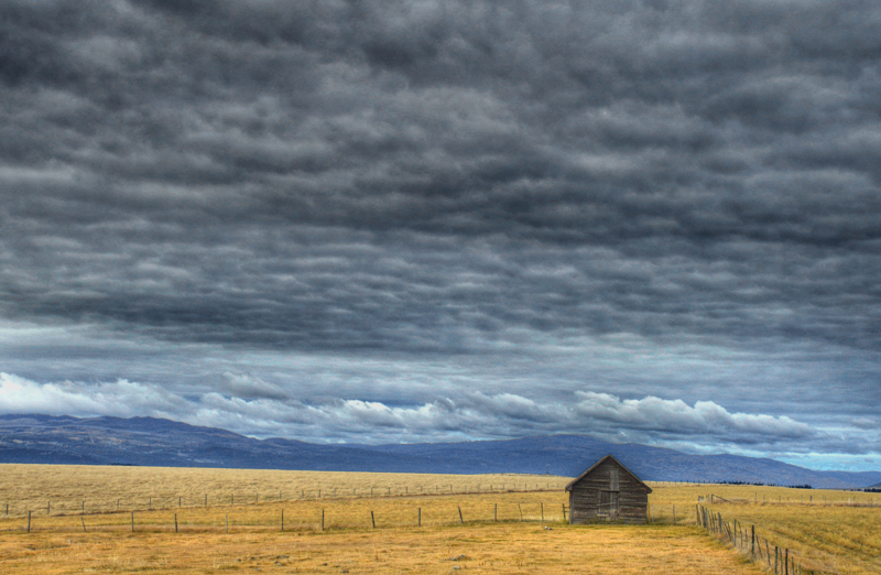 Lone Cabin Under Mottled Sky